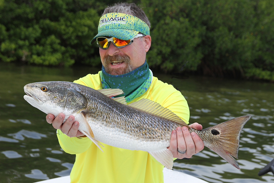 Angler Smiling with Redfish